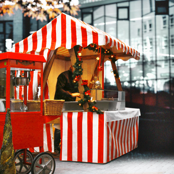 Weihnachtsmarktstand vor Porsche-Verkaufsraum.